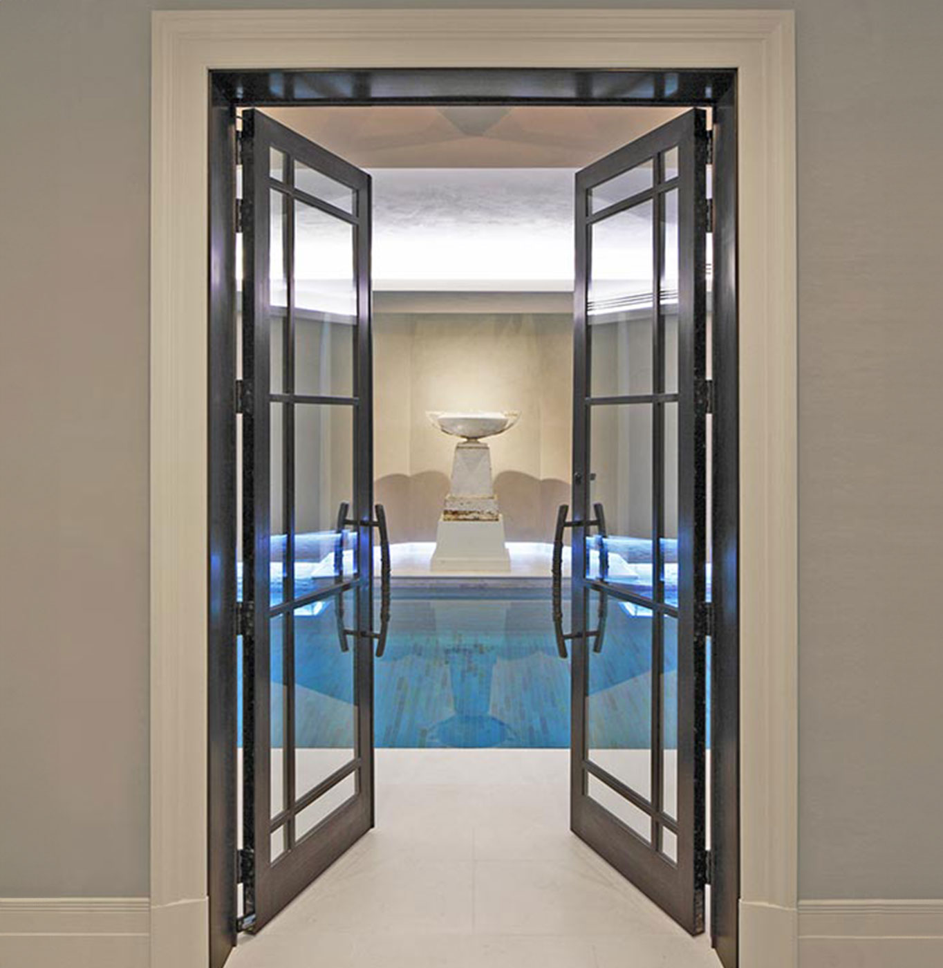 Bronze doors into a pool room