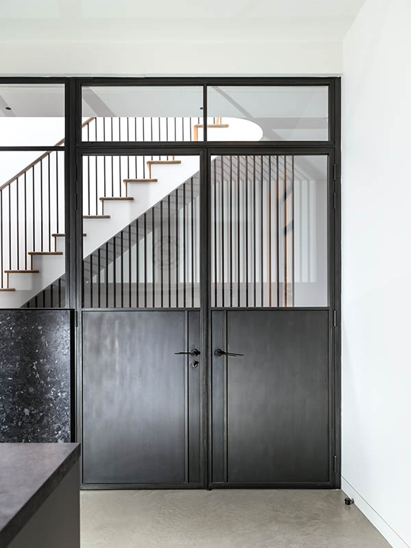 bronze door with panelled bottom half