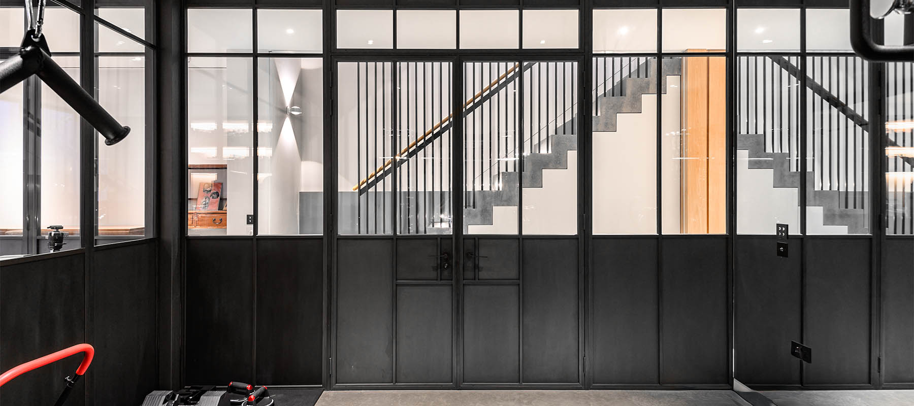 gym with panelled bronze doors