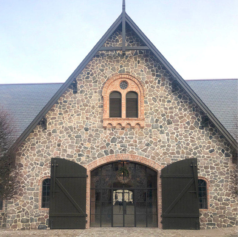 Barn conversion with bronze screen in the daytime