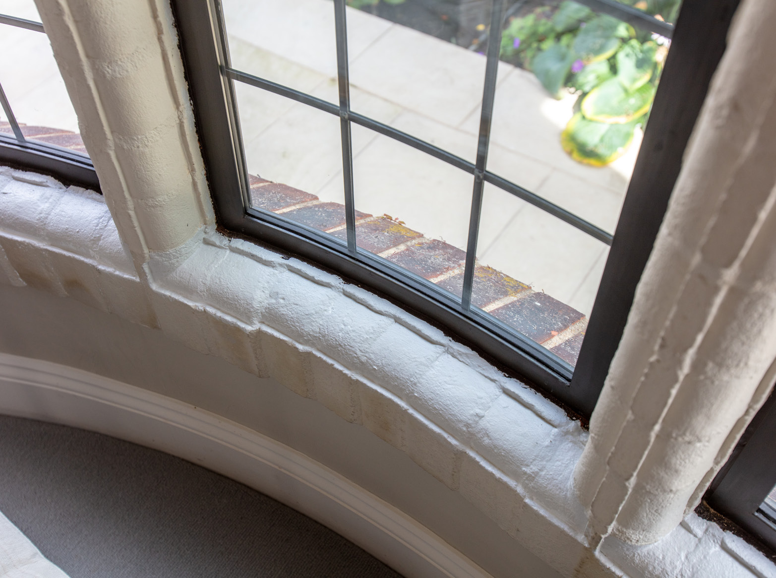 Close up of bronze bowed windows