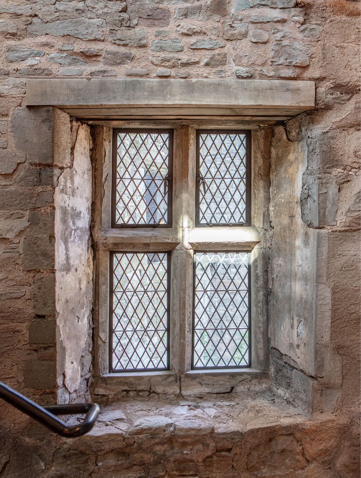 Four bronze windows in stone mullions
