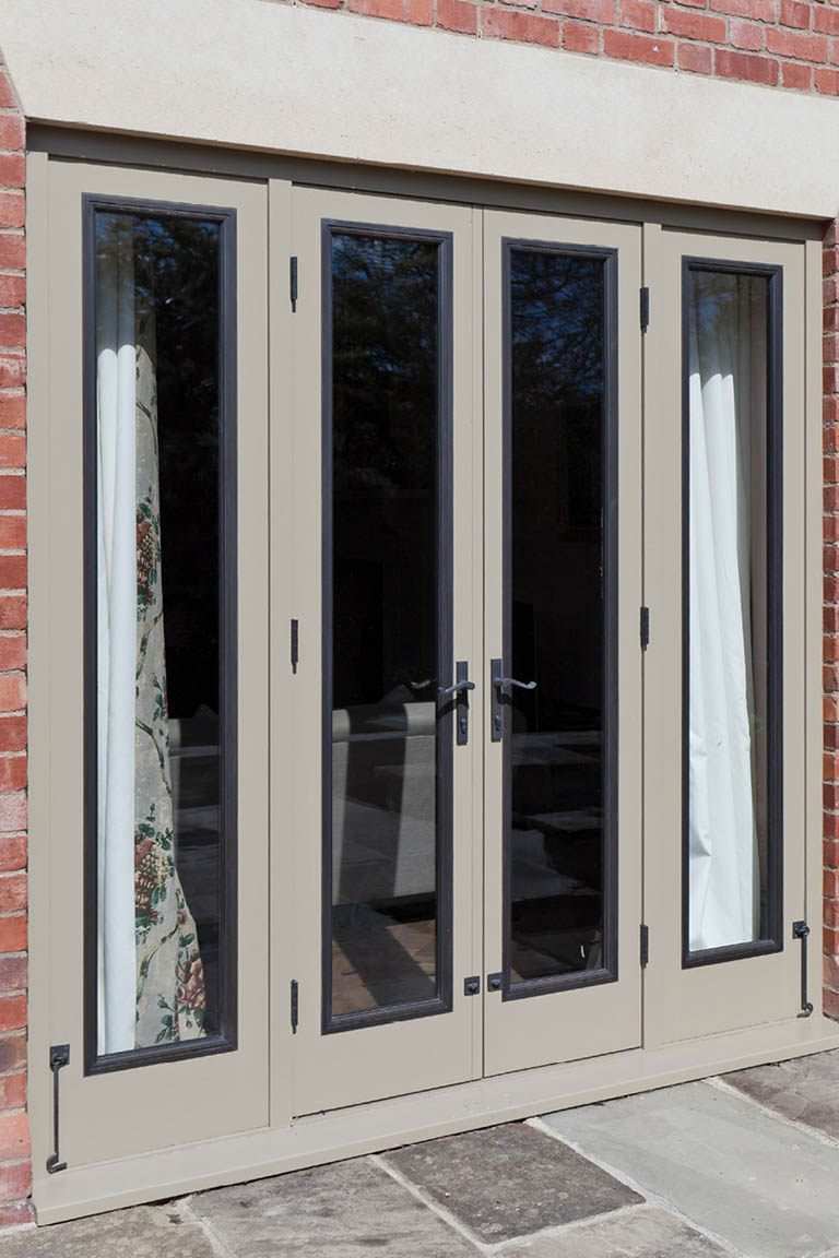 grey painted timber doors with bronze inserts