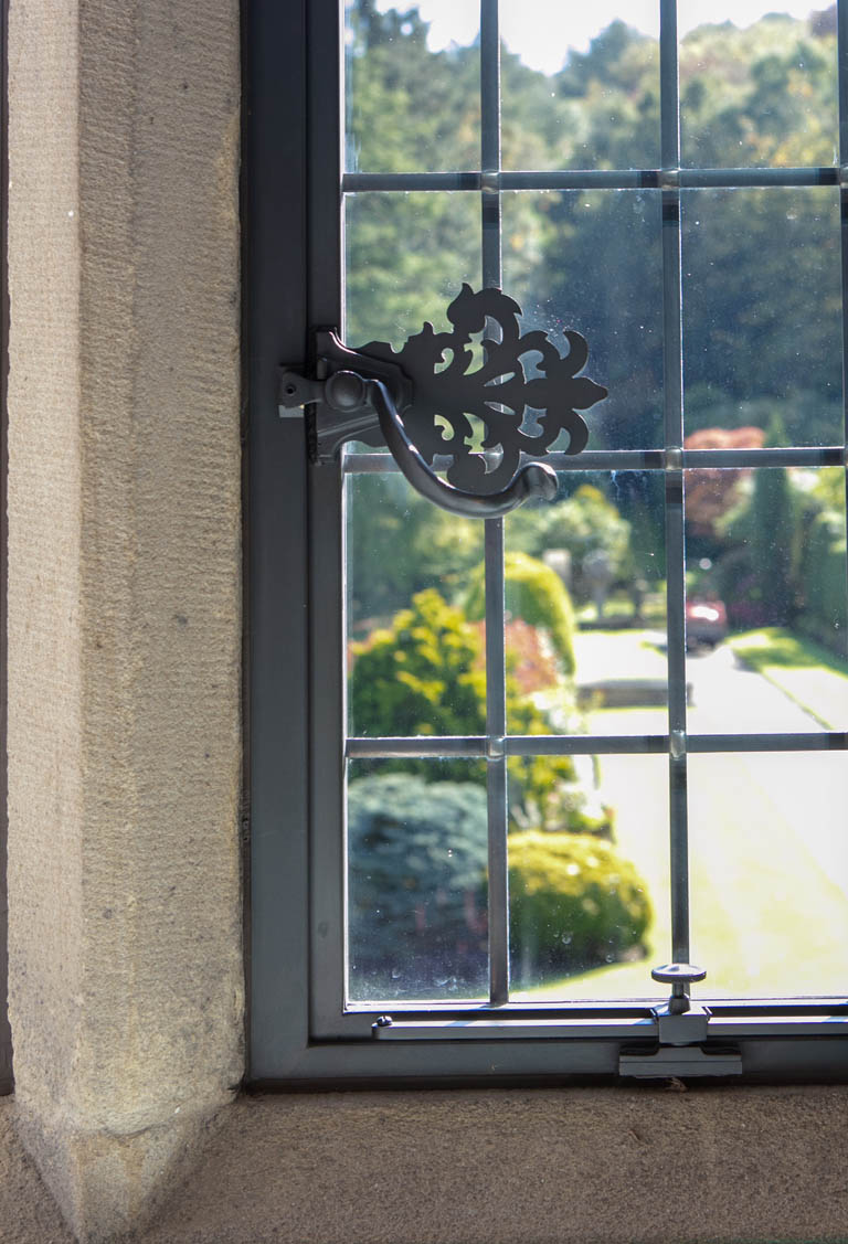 Close-Up of Bronze Handle and Window