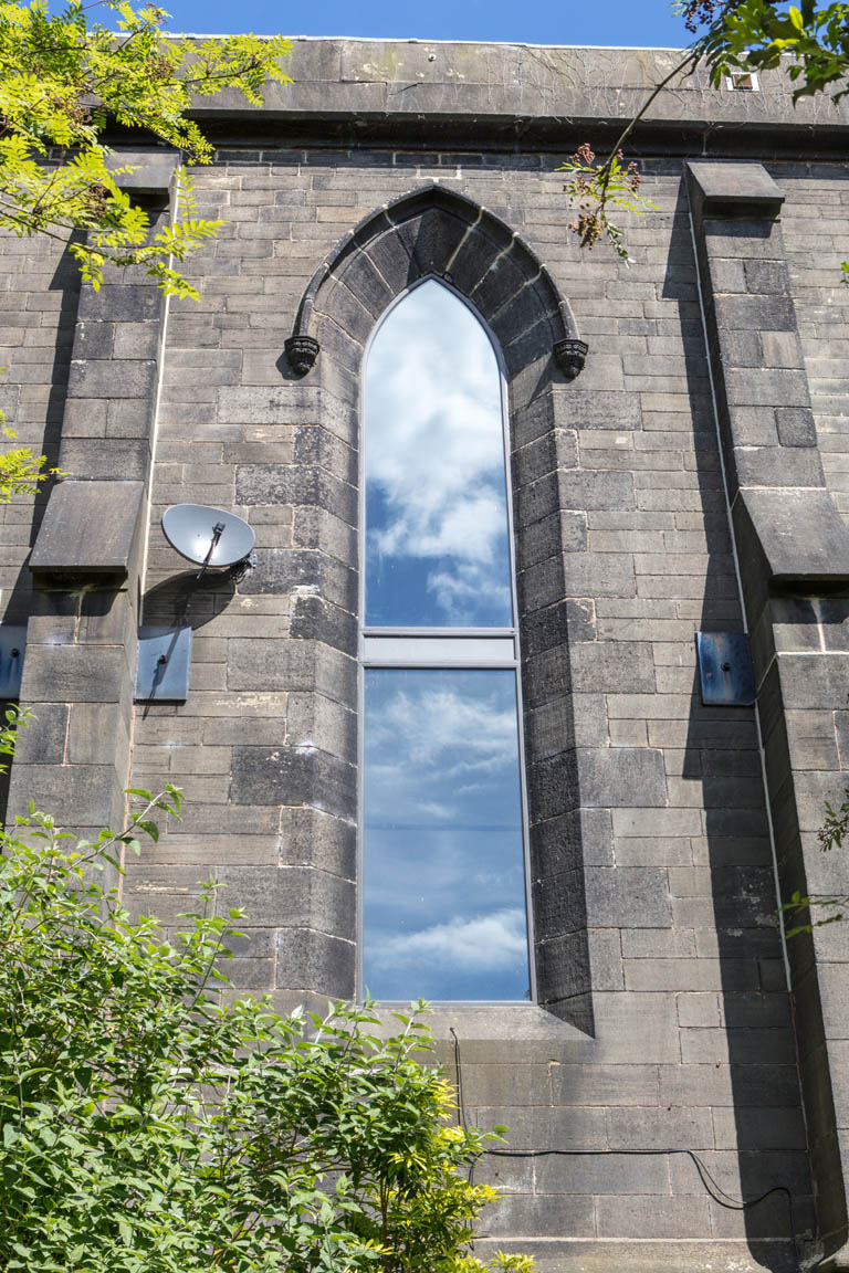 Large Panes of Bronze Windows on Church Home Renovation